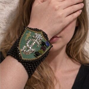 Juicy Couture Black Beaded Cuff with Green Shield